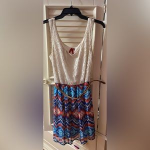 Blue, red, and cream dress with brown waist belt